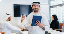 Group of middle-eastern corporate business people wearing traditional emirati clothes meeting in the office in Dubai - Business team working and brainstorming in the UAE